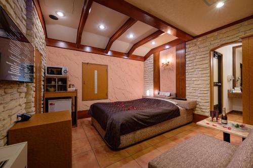 a bedroom with a large bed in a room at Hotel Metro (Adult Only) in Yokohama