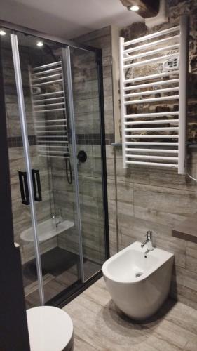 a bathroom with a toilet and a sink and a shower at La pietra di Sersa in Quaratica