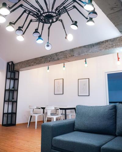 a living room with a blue couch and a table at Kazbegi Apartments in Stepantsminda