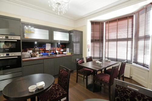 a kitchen and dining room with a table and chairs at Tennyson in Lincoln
