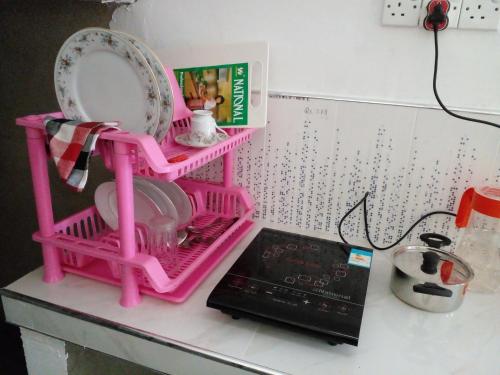 a pink drying rack on top of a kitchen counter at Villa Ameliya in Unawatuna