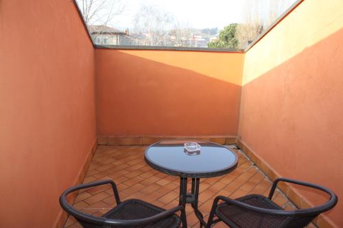 a small patio with a table and two chairs at La Dolce Vita in Montecchia di Crosara