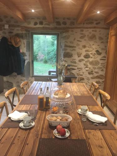 een houten tafel met eten erop in een kamer bij La Grange De L’Abille in Marchastel