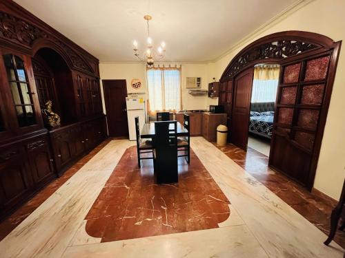 a large living room with a table and a kitchen at Mega Suite in Privileged area of San Marino in Guayaquil