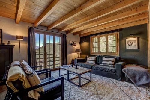 a living room with a couch and a table at Chalet Cabana Luna in La Tzoumaz
