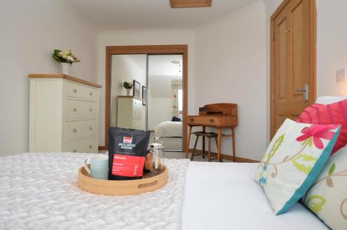 a bedroom with a bed with a tray on it at Kennacraig Lodge in Whitehouse