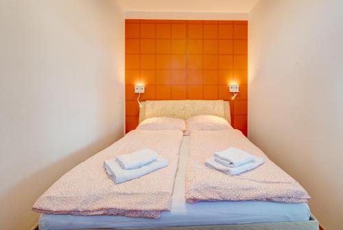 a bedroom with two beds with towels on them at Aleda Kaskada in Szczecin