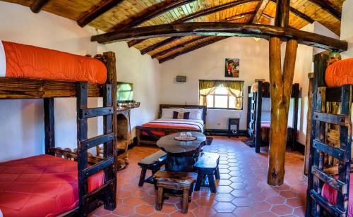 a bedroom with two bunk beds and a bed at Hacienda Turistica Intihuatana in San Fernando