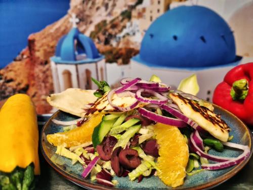 a plate of food with a salad on a table at Hotel Malinowski Economy in Gliwice