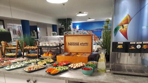 a buffet of food on a counter in a store at Hotel Malinowski Economy in Gliwice