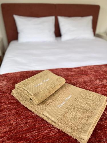 a bed with two towels on top of it at Barros' House in Chaves