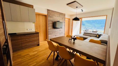 シュラートミンクにあるApartment SCHLADMING - Planai viewのキッチン、ダイニングルーム(テーブル、椅子付)