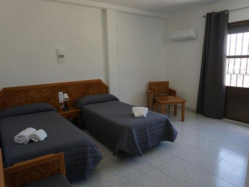 En eller flere senger på et rom på Hostal La Reserva