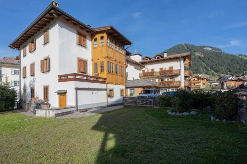 a large house in a village with a yard at Cesa Meida 3 in Pozza di Fassa