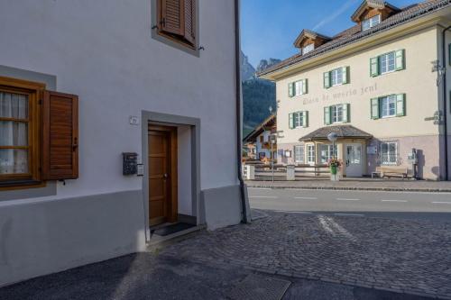 a view of a street in a town with a building at Cesa Meida 3 in Pozza di Fassa