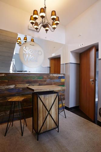 a restaurant with a table and stools in a room at SleepWell Apartments Ordynacka in Warsaw