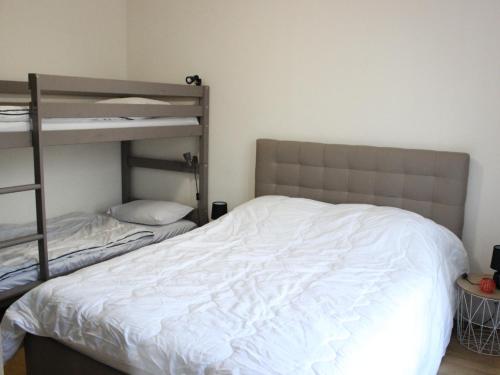 a bedroom with a bed and a bunk bed at Maison de vacance in Cabourg