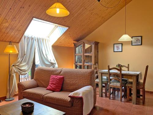 a living room with a couch and a table at Casas rurales Valle de El Paular in Rascafría