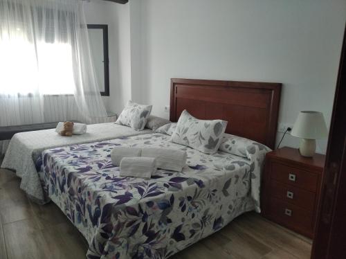 a bedroom with a bed with a teddy bear on it at La Teja del Jerte 