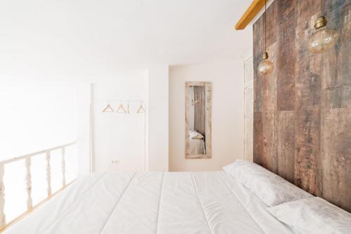 a bedroom with a large bed and a brick wall at SnowSun in Sierra Nevada