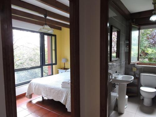 a bathroom with a bed and a sink and a toilet at Casa Pancho Porrúa in Porrúa