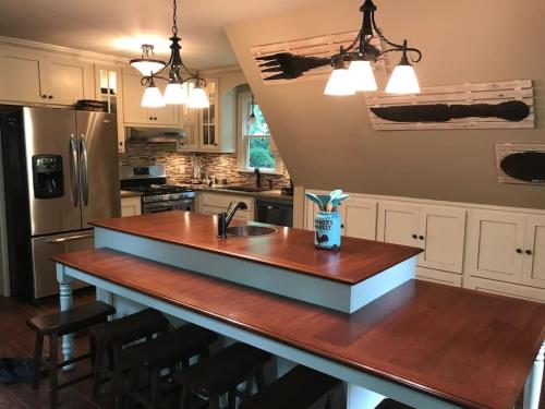 a kitchen with a kitchen island with a sink at Farmhouse in a Peaceful Paradise with Huge Hot tub in Gainesville