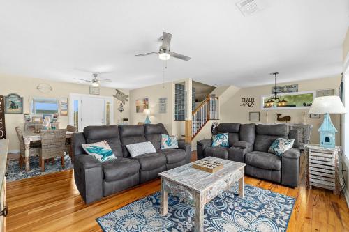a living room with two couches and a table at Seaside Serenity Direct Oceanfront in Ormond Beach