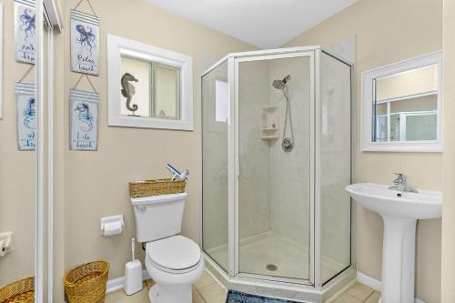 a bathroom with a shower and a toilet and a sink at Seaside Serenity Direct Oceanfront in Ormond Beach