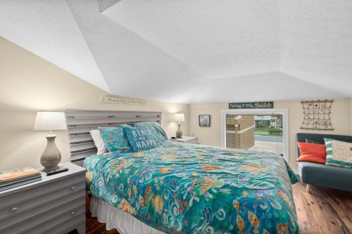 a bedroom with a bed and a couch at Seaside Serenity Direct Oceanfront in Ormond Beach