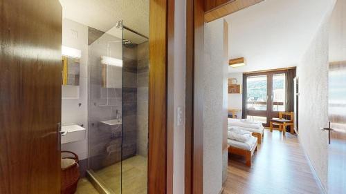 a bathroom with a glass shower and a sink at St. Moritzerhof 51 in St. Moritz