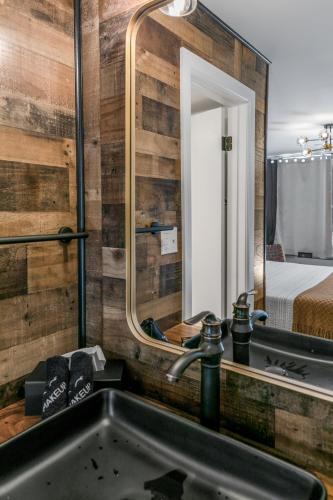 a bathroom with a sink and a mirror at Candlewick Inn and Suites in Eureka Springs