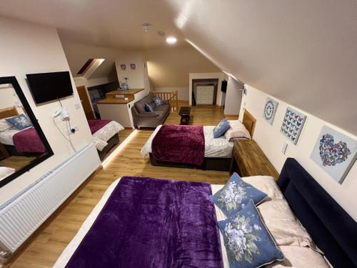 a room with two beds and a couch at Kylemore Pass Hotel in Letterfrack