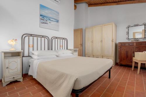 una camera da letto con un grande letto bianco e un tavolo di Casa Mare e Monti a Cannigione