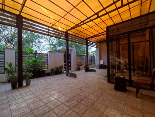 a large patio with plants and a yellow ceiling at Zest hotel & spa in Oral