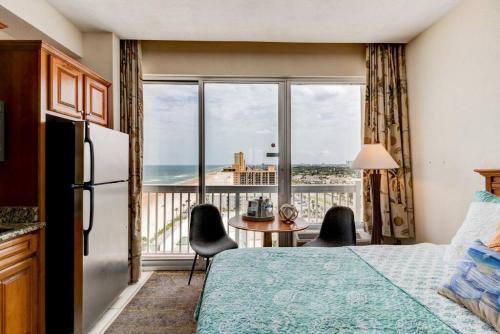 a bedroom with a bed and a view of the ocean at Driftwood Dreams at the Beach in Daytona Beach
