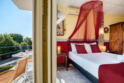 a bedroom with a bed and a balcony at Plexus by DON in Eforie Sud
