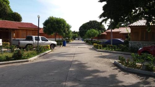 a street with a truck parked on the side of the road at VILLAS DEL PALMAR APTO 406 in Santa Marta