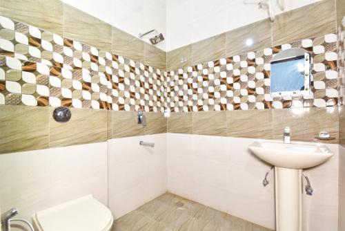 a bathroom with a sink and a toilet at Hotel Sai Sham in Amritsar