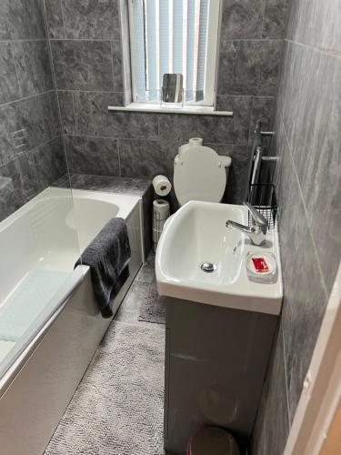 a bathroom with a sink and a bath tub at Urban view in Doncaster