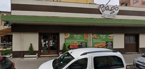 a white car parked in front of a restaurant at Kreart Suite & Rooms B&B in Crotone