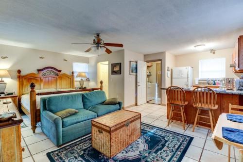 a living room with a blue couch and a kitchen at Good Old Days Cottage King Bed Pet Friendly in Daytona Beach