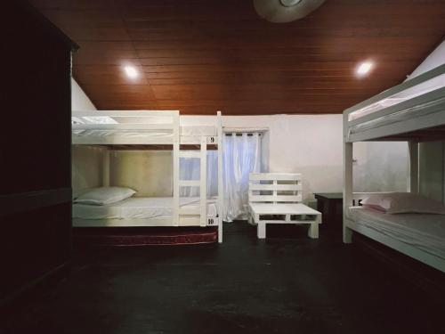 a room with two bunk beds and a chair at Bunk house Fort Kochi in Cochin