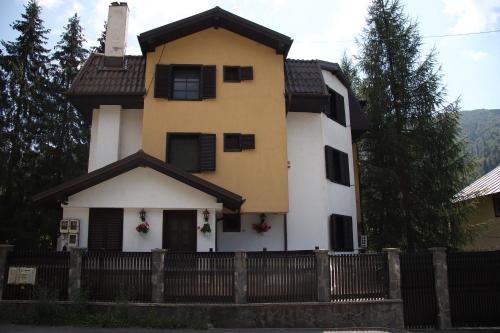 a house with a fence in front of it at № 32 in Azuga