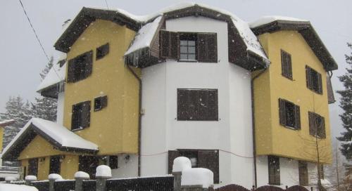 a building with snow on the top of it at № 32 in Azuga