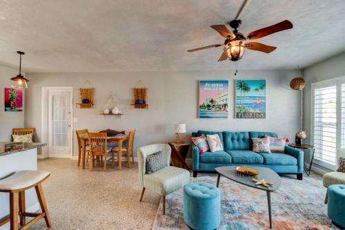 a living room with a blue couch and a table at 3 Bed 2 Ba Wifi Kitchen Walk to Beach FirePit in Daytona Beach