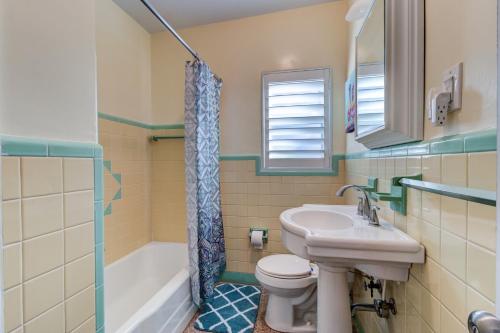 a bathroom with a sink and a toilet and a tub at 3 Bed 2 Ba Wifi Kitchen Walk to Beach FirePit in Daytona Beach