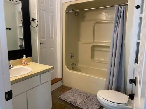 y baño con aseo, lavabo y ducha. en Relaxing 3 bed 2 bath Wifi by the Intercostal, en Daytona Beach