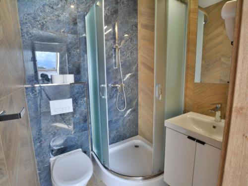 a bathroom with a shower and a toilet and a sink at Cosy apartment for 2 persons right by the sea, Ustronie Morskie in Ustronie Morskie