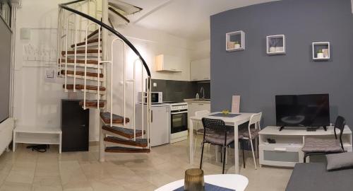 a living room with a kitchen and a spiral staircase at Apartman Mia in Slavonski Brod