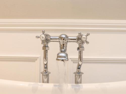 a water faucet with water coming out of it at Wild Acres in Helston